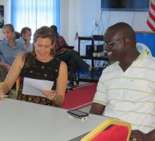 Adrie Kusserow looks over writing during a one-on-one workshop session in South Sudan..jpg