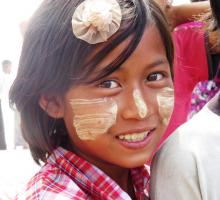 16-Girl with Thanakha (traditional face painting). Many women (and men) do this because it cools the skin, acts as sun block, and leads to more beautiful skin..jpg