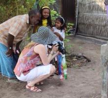 Jamby Djusubalieva shares her photo with a local family during the group's tour of a local island.jpg