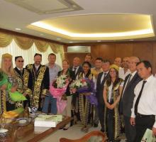 8-Meeting with members of the Uzbekistan Writers Union (American writers donning traditional robes and hats).jpg