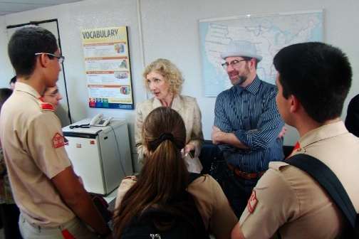 Two people talk to a group of students.