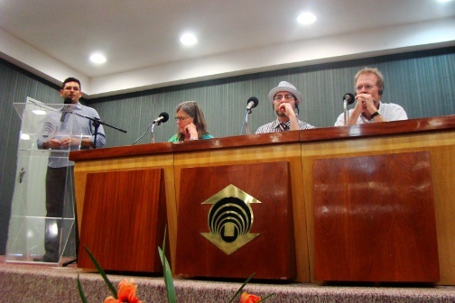 Four people speak at a panel.