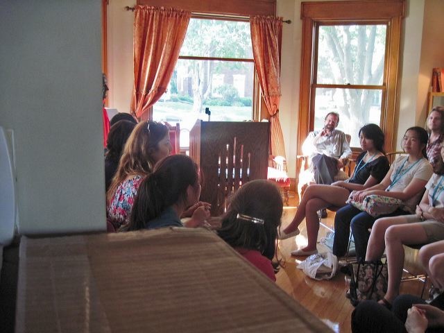 Between the Lines participants sit in a circle at Shambaugh House and discuss the events of "Arab Spring."