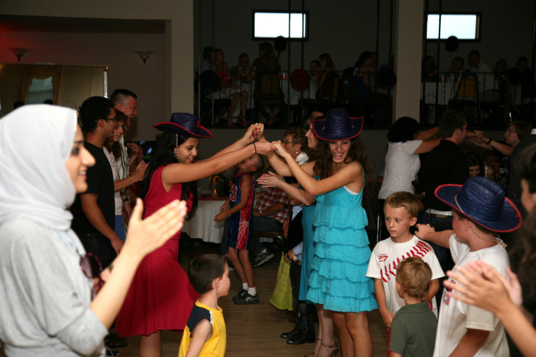 Between the Lines participant do an old-fashioned barn dance at a wedding reception in Walcott, Iowa.