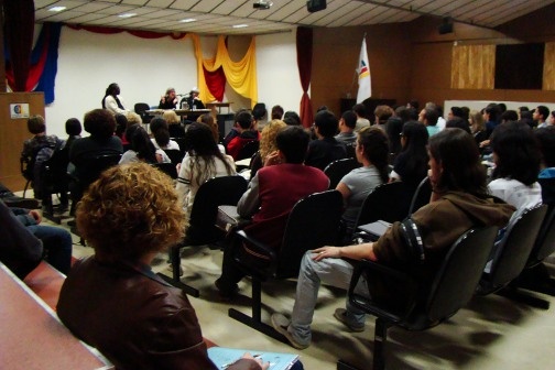 A classroom full of people watch the writer's presentation.