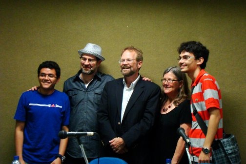 Students pose for a photo with Chris Merrill