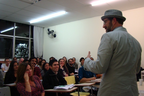 A man presents before a classroom full of people.