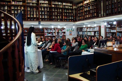 A man presents in front of a roomful of people