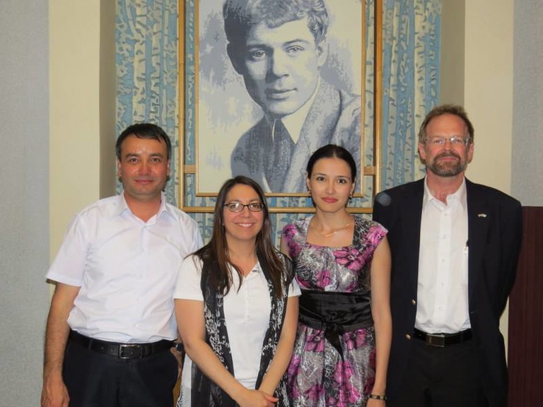 IWP alum Aazam Abidov, IWP program officer Kelly Bedeian, IWP alum Alina Dadaeva & Chris Merrill pose for a photo.