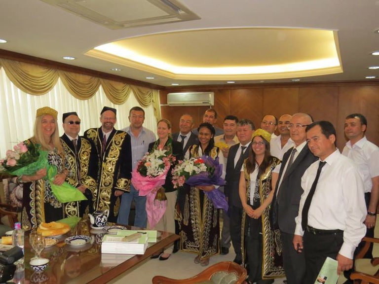 Meeting with members of the Uzbekistan Writers Union (American writers donning traditional robes and hats).