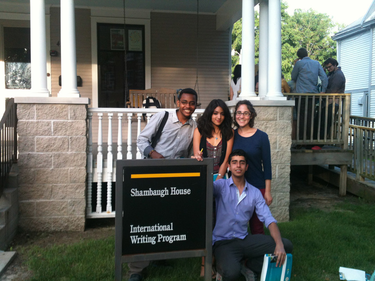 A group of four Between the Lines participants pose by the Shambaugh House sign.