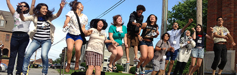 A group of Between the Lines participants pose for a photo mid jump.