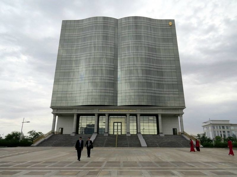 The Palace of Creativity in Ashgabat, a giant stone building shaped like an open book.