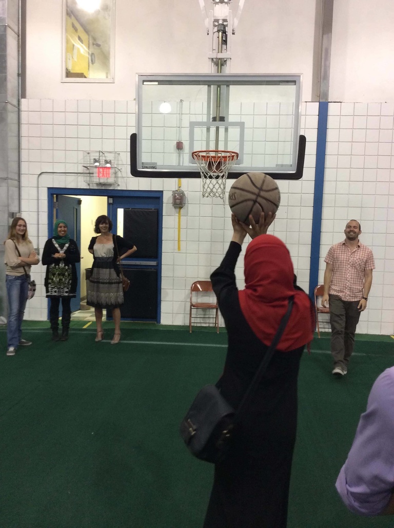 A group of Between the Lines participants play basketball at a local mosque