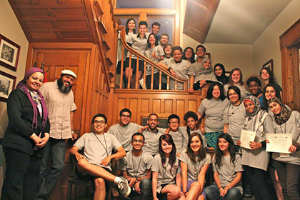 A group of Between the Lines participants pose in their BTL T-shirts on the last night of the session.