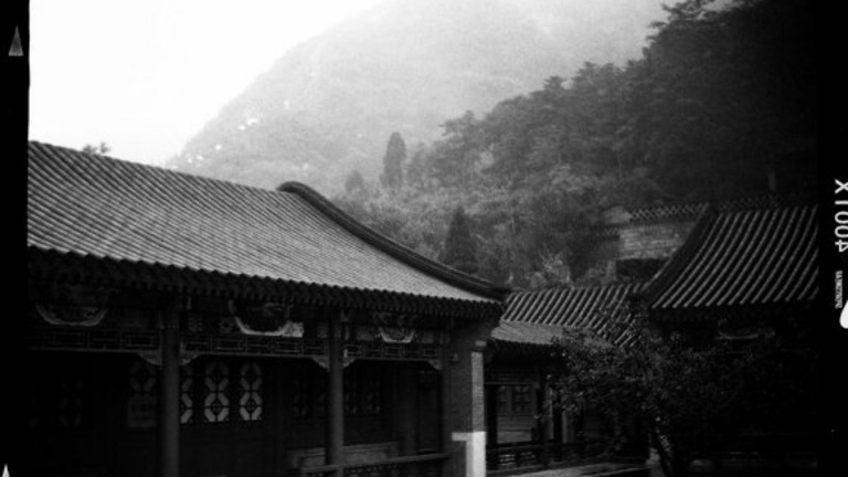 Part of the museum complext at Juyongguan. The Great Wall is visible as a pale line ascending the hillside in the upper-left. 
