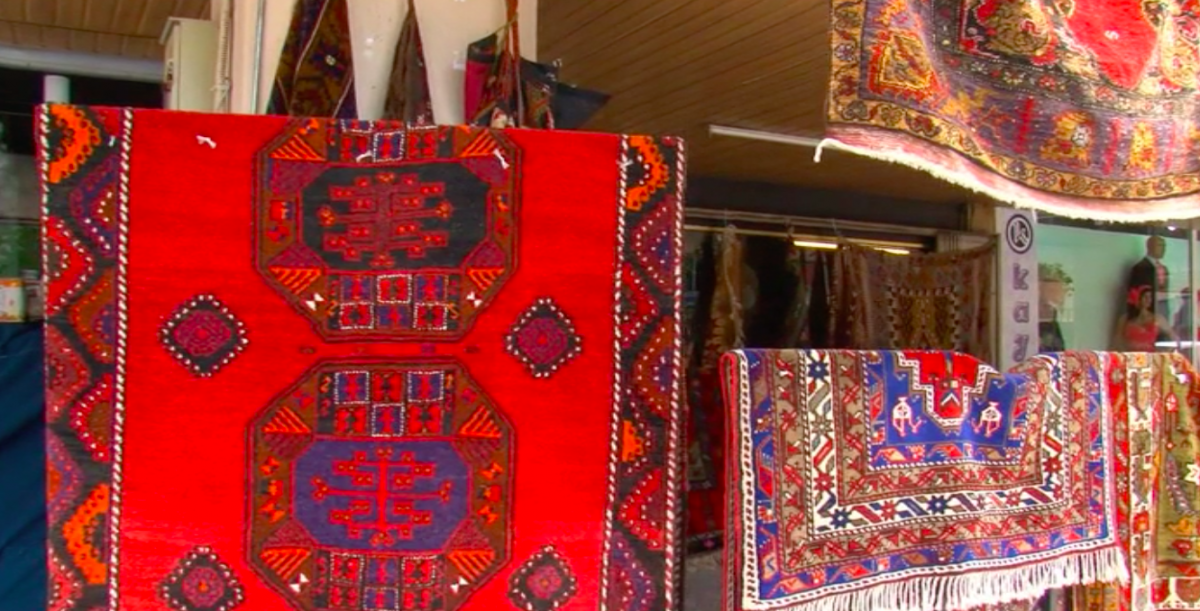 Scarlet rugs with intricate designs hang