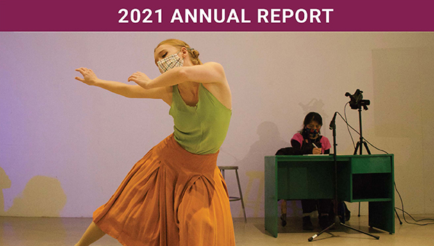 The cover of the IWP 2021 Annual Report; features a person dancing in a mask and dress in the foreground while another masked person writes at a desk in the background.